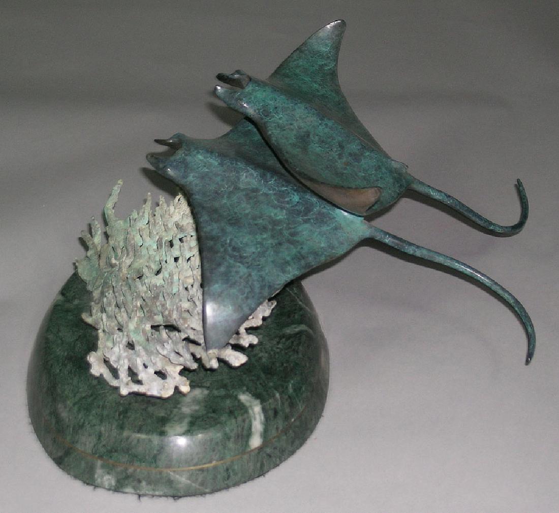 Robert Wyland Bronze, "Manta Rays": Robert Wyland (American, b.1956), circa 1991 patinated bronze sculpture, titled "Manta Rays", edition 31/300, 17" long, 9" high, raised on an oval green marble base. Accompanied by a certificate from 