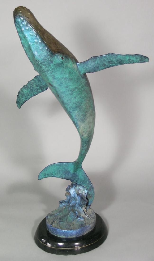 Robert Wyland Bronze, "Ocean Celebration": Robert Wyland (American, b.1956), circa 1991 patinated bronze sculpture, titled "Ocean Celebration" depicting a breeching whale, edition 25/200, 31 1/4" high, raised on an oval black marble base. Acco