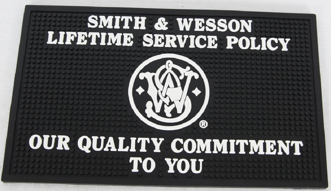 S & W LIFETIME SERVICE POLICY COUNTER MAT: S & W LIFETIME SERVICE POLICY COUNTER MAT Heavyweight with nubby topside protects both table surface and gun while cleaning approx size is 14.5 x 8 3/4" 1/4" thickness, great mat to work on or clean y