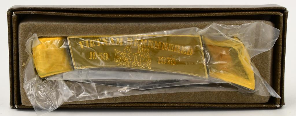 Commemorate Vietnam Remembered Folding Knife: Commemorate Vietnam Remembered Folding Knife, Gold Tone Color, Vietnam Remembered 1859 - 1935 Marked Folding Commemorate Knife. New In Box Measures Approx 4 1/4" Closed