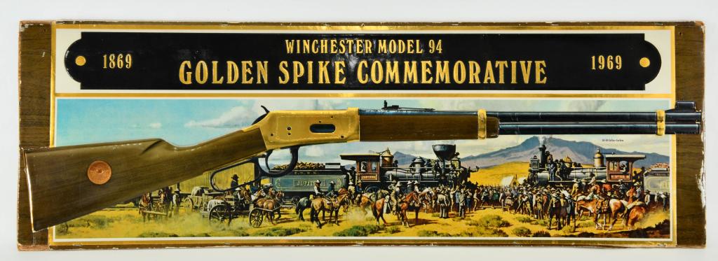 Winchester Model 94 Golden Spike Commem. Sign: Up Next We Have an Original Winchester Model 94 Golden Spike Commemorative Store Display Sign Measures 37 1/2" long and 12 1/2 High Made of Cardboard, and Backed on Wood. Great Display For The Man Cav