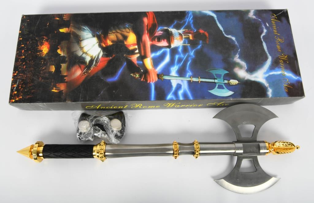 New In The Box Ancient Rome Warrior Fantasy Axe: Attention, bidders! Feast your eyes on the New In The Box Ancient Rome Warrior Axe, accompanied by a wall mount for display. This impressive piece measures approximately 22" long and 7" wide at the bl