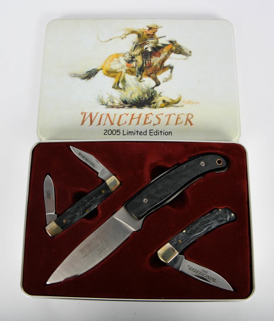 Winchester 2005 LE Collector Knife Set: Lot contains a Winchester 2005 Limited Edition Collector Knife set in tin case; There is Two Folding knives to this set and one Dagger with the Belt Looped Canvas sheath, great gift idea for the knife
