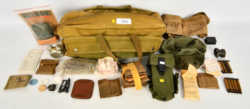 Military Bandoleer, Holster & Gun Cleaning ACC: Greetings esteemed bidders! Up for auction is a diverse lot of military accessories, including bandoleers, a holster, gun cleaning accessories, oil canteens, a hat, patches, and a large carry bag.