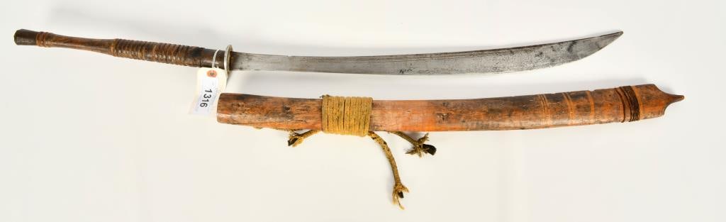 East African Long Blade sword W/ wood scabbard: Hello Bidders! Up for auction is an East African long blade sword, complete with a wood scabbard. This unique and culturally rich piece showcases traditional craftsmanship and is perfect for collector