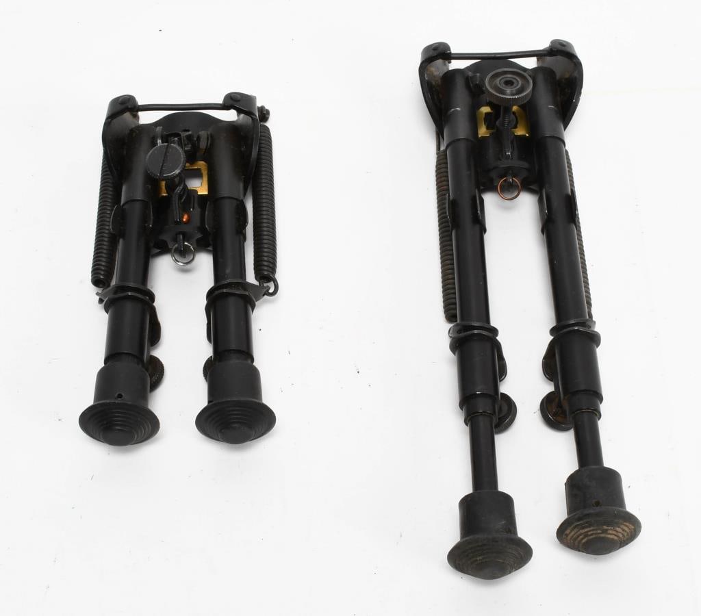 (2) Tactical Adjustable Bipods: one bipod measures approx 7" all closed up, adjustable legs, spring loaded, black, unmarked the other bipod is approx 10.25" all closed up and is adjustable, spring loaded, black and unmarked mfg. bot