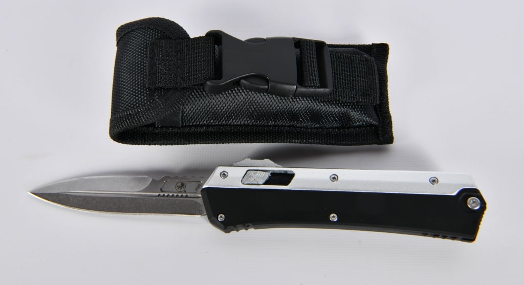 CLONE of a Microtech Glykon OTF Automatic Knife: This is a Copycat, It is a very good job, but it is not real. Sheath; Black Alum + Titanium (3.75" Apocalyptic) Named for the Roman snake god, the Microtech Glykon is an out-the-front automatic knife