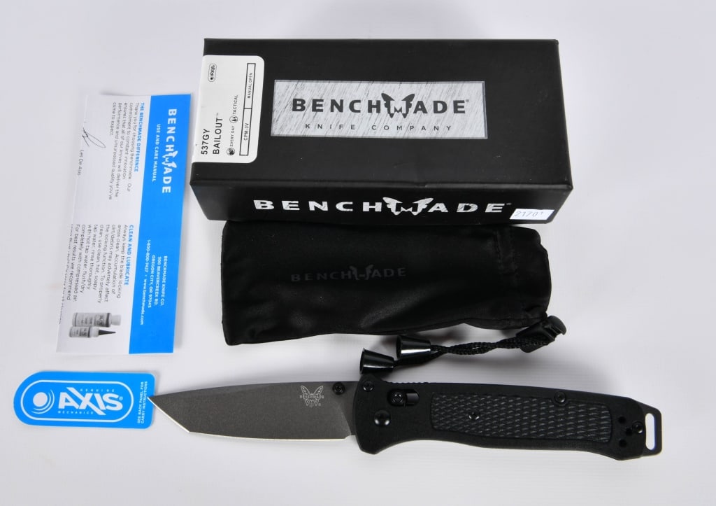 New In Box Benchmade 537GY Bailout Knife: Looking to fly under the radar? The slim and ultralight design of the Bailout offers users an optimal strength-to-weight ratio. Black Grivory handles, a tanto CPM-3V blade, and aluminum pommel complet
