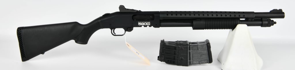 Mossberg 590M Mag Fed Pump Action Shotgun: Up Next We Have a Mossberg 590M Mag Fed Pump Action Home Defense Shotgun Chambered in 12 Gauge, Comes With One 10 Round Magazine, 18 1/2" Barrel, No Front SIght, Heat Shroud, Synthetic Furniture, and 