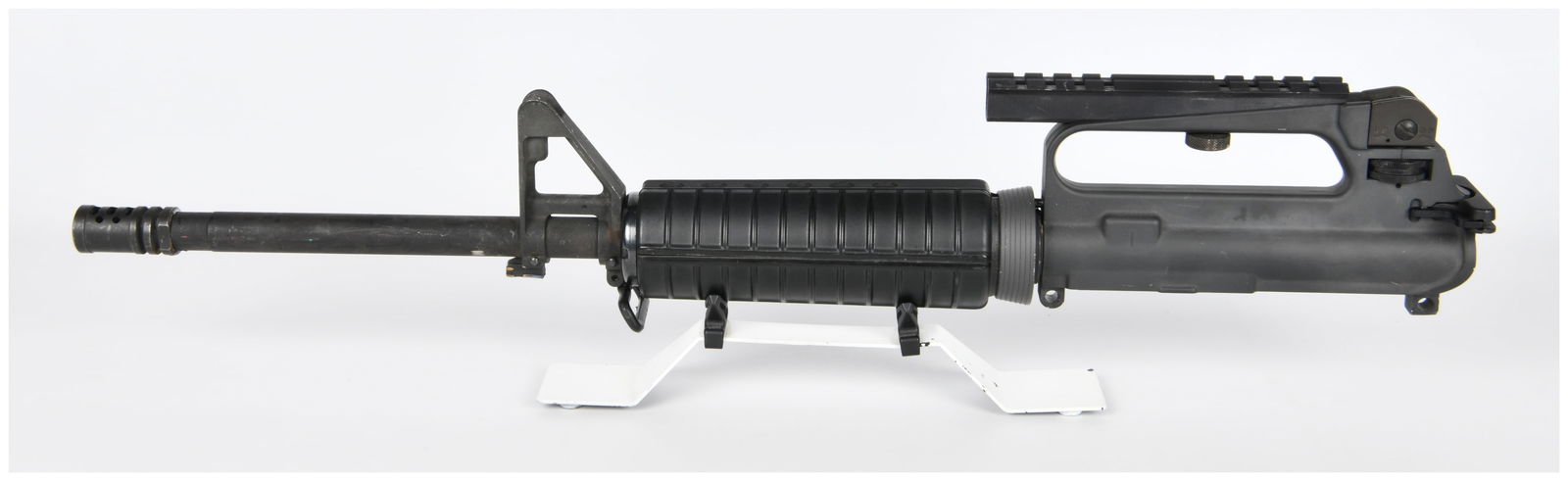 Colt AR-15/M16 Upper Receiver Assembly with BCG, Bayonet Lug Ground Down: A Colt AR-15/M16 style upper receiver assembly, complete with Bolt Carrier Group (BCG) and a bayonet lug that has been ground down. This black-finished assembly is characteristic of a late 20th to ear
