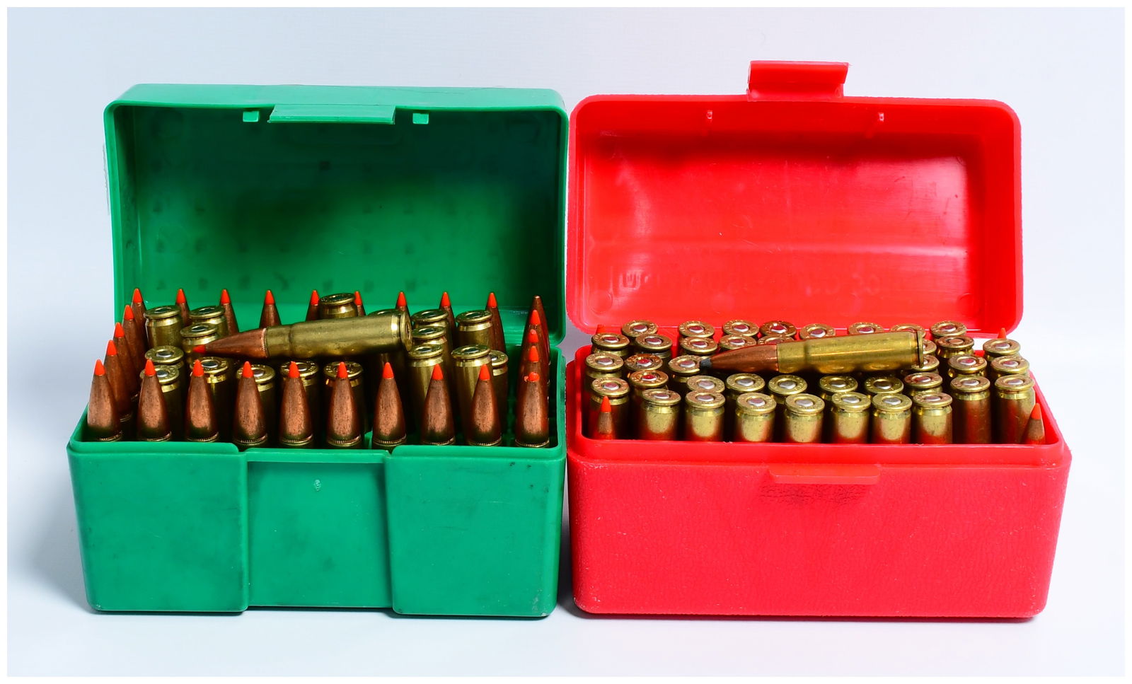 100 Rounds .300 BLACKOUT Ammunition and Fired Casings in MTM Storage Boxes: A collection of .300 BLACKOUT ammunition and fired casings housed in two MTM plastic storage boxes. The lot comprises 100 Rounds .300 BLACKOUT. The green MTM box contains approximately fifty loaded ri