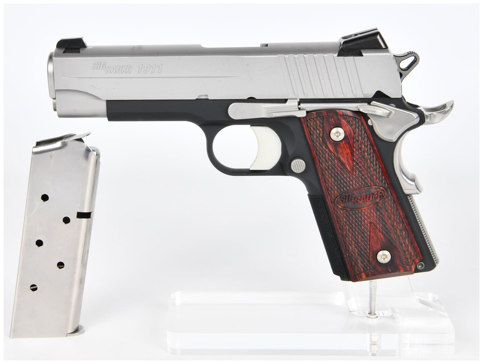 Sig Sauer 1911 C3 .45 Auto Semi-Automatic Pistol: A Sig Sauer 1911 C3 .45 Auto semi-automatic pistol. This modern pistol features a two-tone design with a brushed metal slide and a black frame. It is fitted with checkered reddish-brown wood grips, ea