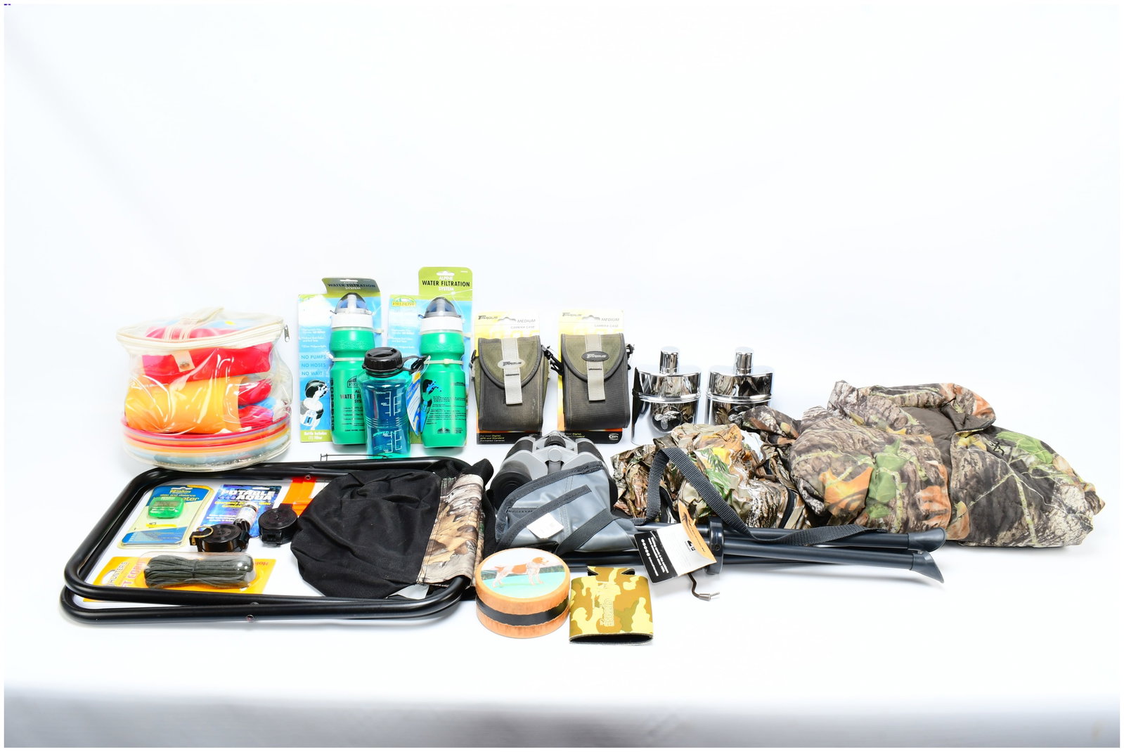 A Collection of Modern Outdoor, Hunting, and Survival Equipment: A varied collection of modern outdoor, hunting, and survival equipment, largely presented in new or excellent condition with several items still in their original packaging. The collection features a 