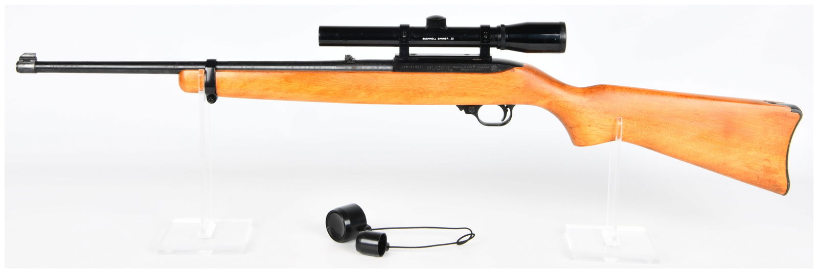 Ruger Model 10/22 Carbine .22 LR Semi-Automatic Rifle with Bushnell Banner Scope: A Ruger Model 10/22 Carbine semi-automatic rifle, chambered in .22 LR caliber, featuring a light-colored wooden stock, blued steel barrel and receiver, and black synthetic components. It is fitted wit