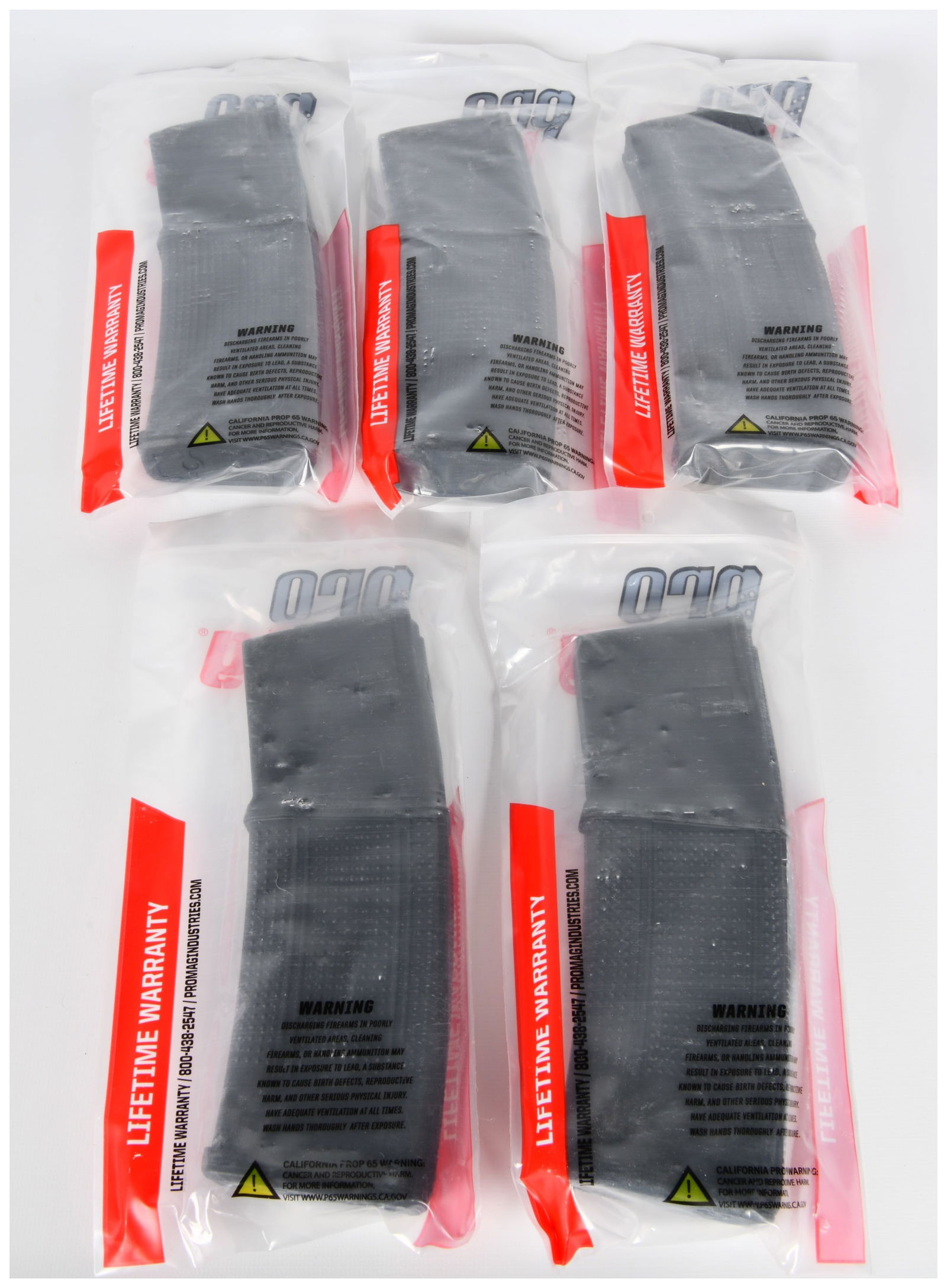 Five Pro Mag AR-15 5.56MM 30-Round RM-30 Black Polymer Magazines: A group of five Pro Mag AR-15 5.56MM 30-Round RM-30 Black Polymer Magazines. Each magazine is new-in-package, sealed in clear plastic packaging. The packaging features the Pro Mag brand logo at the to