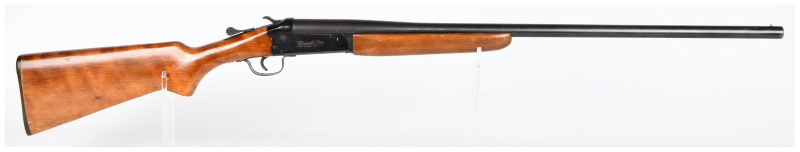 Revelation Model 350 Single Shot 20 GA Shotgun: A Revelation Model 350 single-shot break-action shotgun. The firearm features a blued steel receiver and barrel, complemented by a plain wooden stock and forend, and fitted with a black, ribbed buttpl