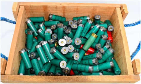 A Collection of Remington Gun Club and Federal 12 Gauge Shotgun Hulls in a Wooden Crate
