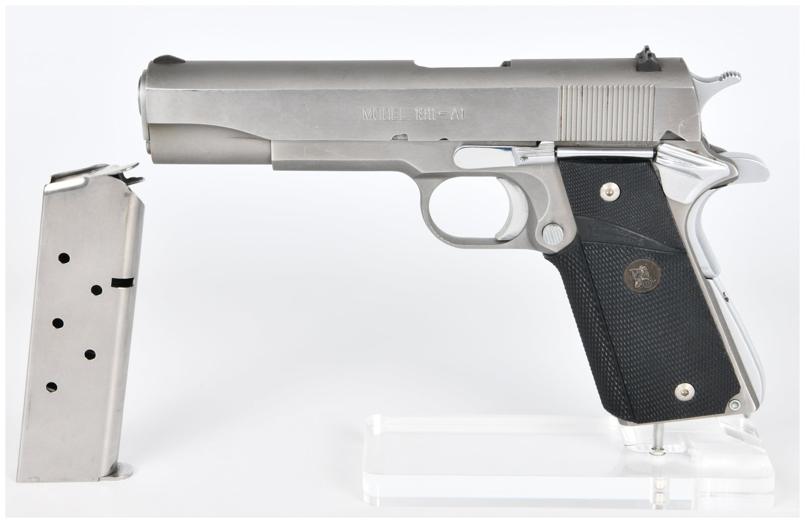 Springfield Armory Model 1911-A1 .45 AUTO Stainless Steel Semi-Automatic Pistol: A Springfield Armory Model 1911-A1 semi-automatic pistol, chambered in .45 AUTO. The pistol is presented in a brushed or matte stainless steel finish and is accompanied by one matching stainless steel