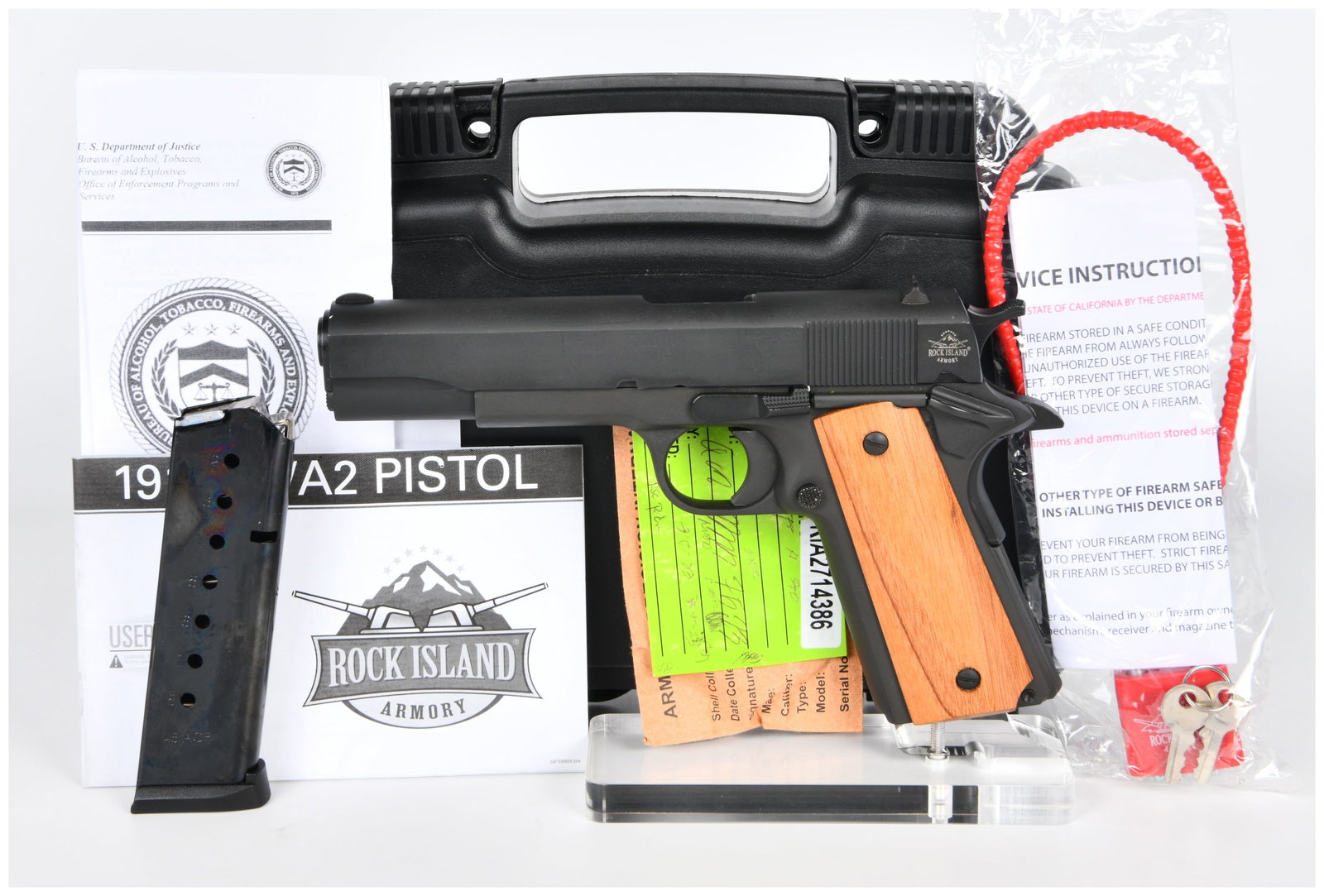 Rock Island Armory M1911 A1-FS GI Standard .45 ACP Semi-Automatic Pistol with Case and Accessories: A Rock Island Armory M1911 A1-FS GI Standard semi-automatic pistol chambered in .45 ACP. The pistol features a matte black finish and light-colored wooden grip panels. Markings on the pistol include R