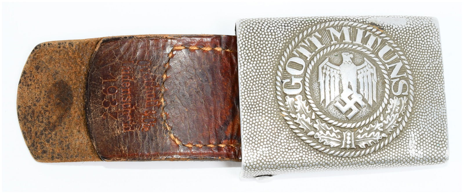 WWII German Heer Aluminum Belt Buckle with Leather Tab: An original World War II German Heer aluminum belt buckle, crafted from a silver-toned metal with a pebbled finish. The buckle features a central circular emblem depicting a stylized eagle clutching a