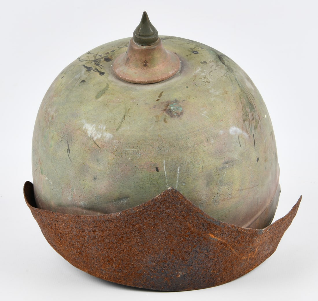 Imperial German WWI Pickelhaube Helmet, Relic Condition: An Imperial German WWI Pickelhaube helmet. The dome is constructed from a copper alloy, exhibiting significant verdigris and general tarnishing. A pointed spike finial, likely bronze or brass, is atta