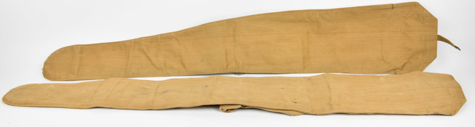 A Pair of WWII British Lee Enfield Rifle Cases: A pair of WWII British Lee Enfield rifle cases, crafted from heavy tan-colored canvas or similar woven textile, featuring metal buckles and straps for securing contents. One case bears stenciled marki