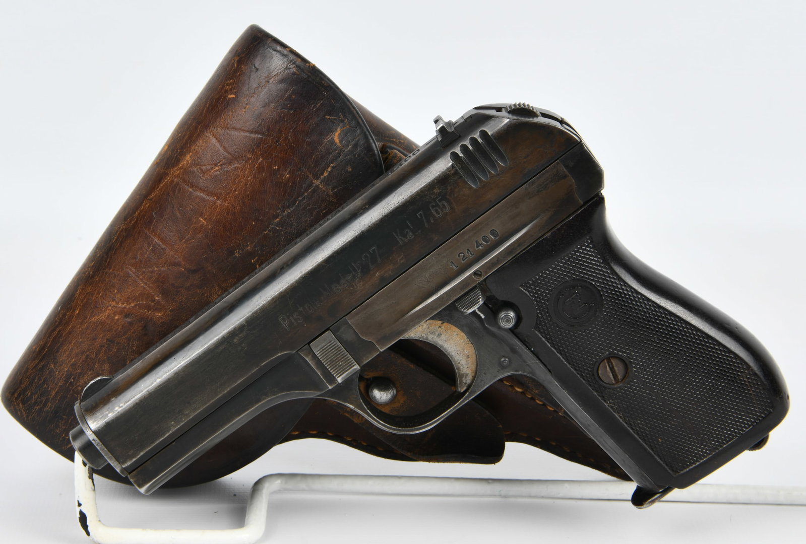 WWII German-Issued CZ Model 27 Semi-Automatic Pistol with Holster: A WWII German-Issued CZ Model 27 semi-automatic pistol, chambered in 7.65mm (.32 ACP). The blued metal pistol is marked "Pistole Modell 27 Kal. 7.65" on the left side of the slide and "B?HMISCHE WAFFE