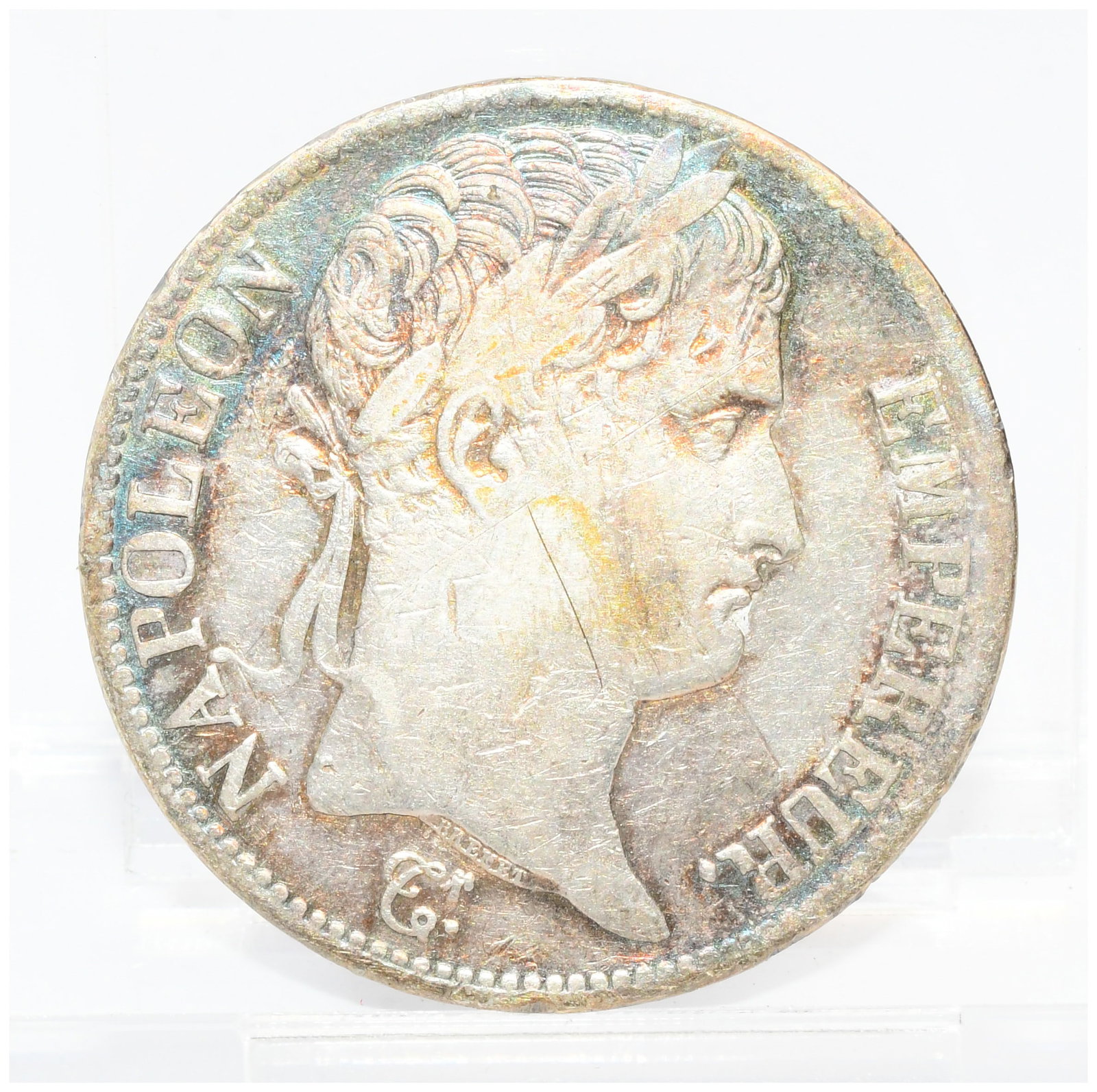 A French Empire 5 Francs Silver Coin, Napoleon I, 1813: A French 5 Francs silver coin, dated 1813, from the period of Napoleon I as Emperor. The circular, silver-colored coin features on its obverse a right-facing laureated profile bust of a man, inscribed