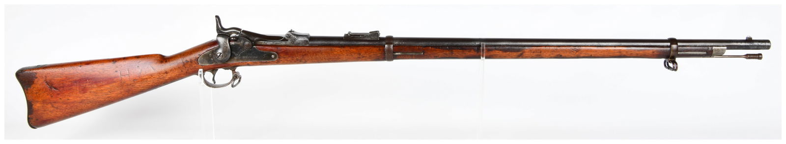 U.S. Springfield Model 1873 Trapdoor Rifle, Dated 1879, .45-70 Caliber: A U.S. Springfield Model 1873 'Trapdoor' breech-loading rifle, dated 1879 on the lock plate, chambered in .45-70 caliber. Constructed with a dark reddish-brown wood stock and blued or patinated steel
