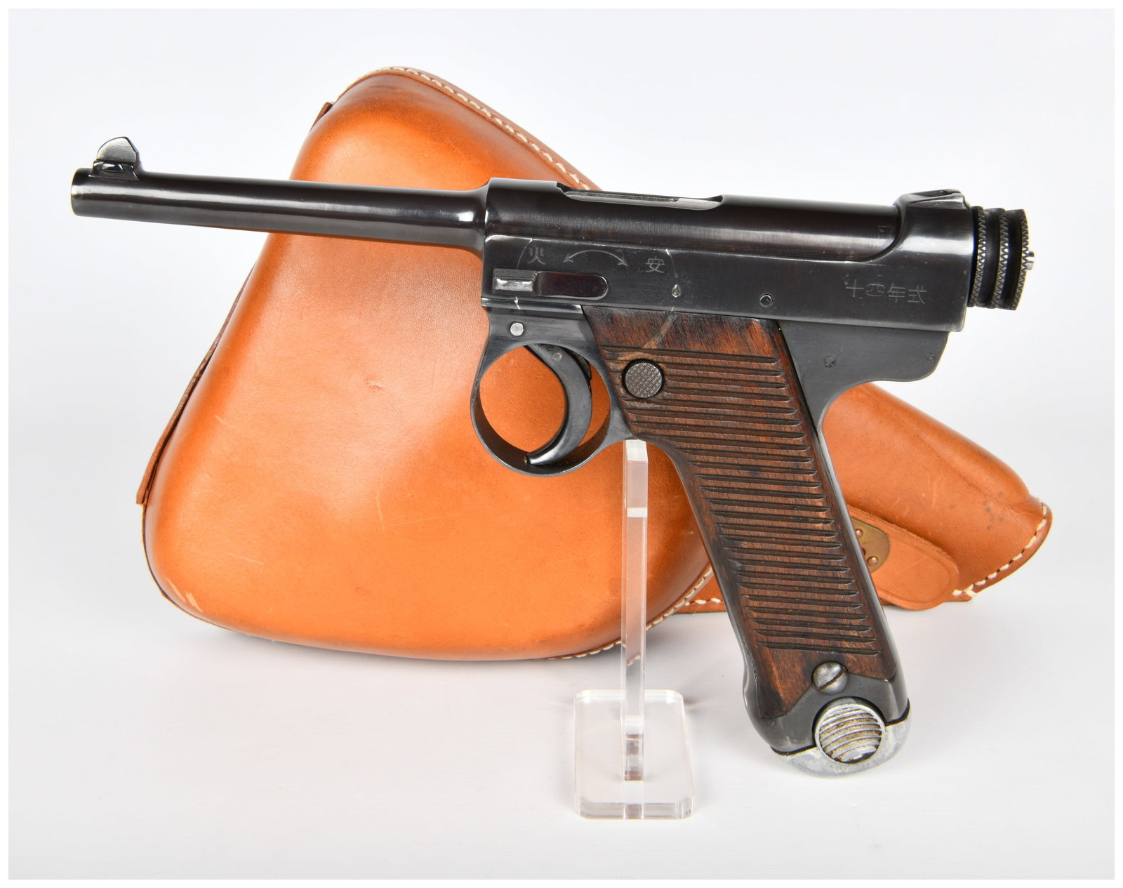 A Japanese Type 14 Nambu Semi-Automatic Pistol, Tokyo Arsenal, Dated October 1929: This lot features a Japanese Type 14 Nambu semi-automatic pistol, produced at the Tokyo Arsenal and dated October 1929 (4th year of Emperor Hirohito's reign, 10th month). The pistol is constructed fro