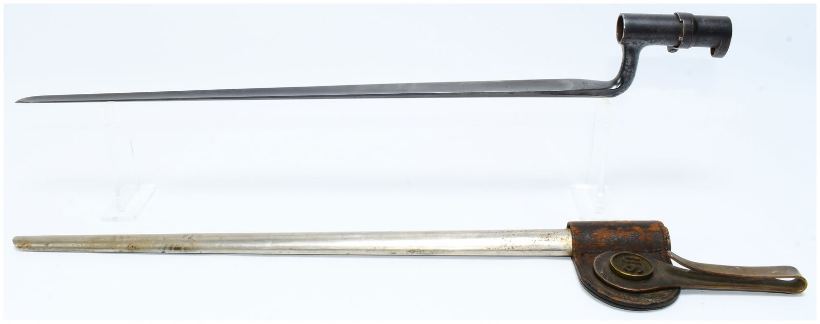 US Military Socket Bayonet with Scabbard and Frog: A US military socket bayonet with its corresponding scabbard and leather frog. The bayonet features a steel cruciform blade, terminating in a blunted tip, attached to a dark, ferrous metal socket with