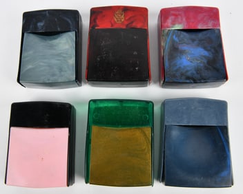 A Group of Six Assorted Thermoset Plastic Cigarette Cases, one with Heraldic Emblem