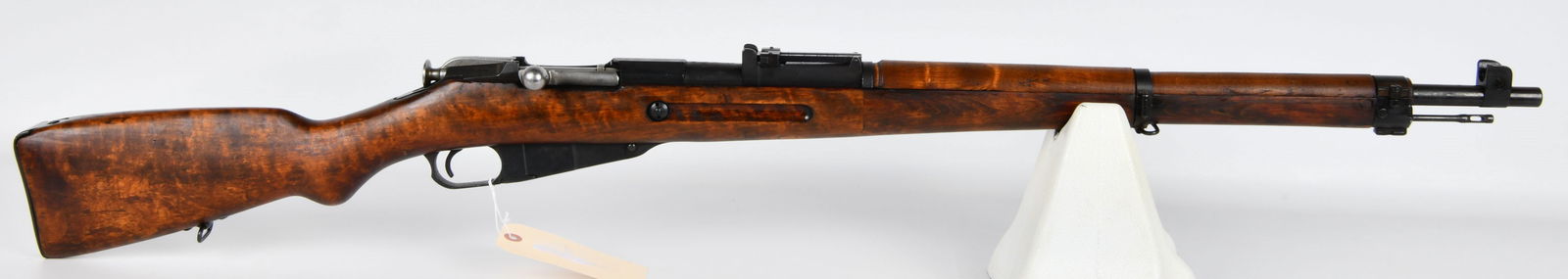 Finnish SAKO M39 Mosin Nagant Bolt Action Rifle, Dated 1942: A Finnish SAKO M39 Mosin Nagant bolt action rifle, dated 1942. The rifle features a reddish-brown finished hardwood stock and blued steel components for the barrel and receiver. Receiver markings incl