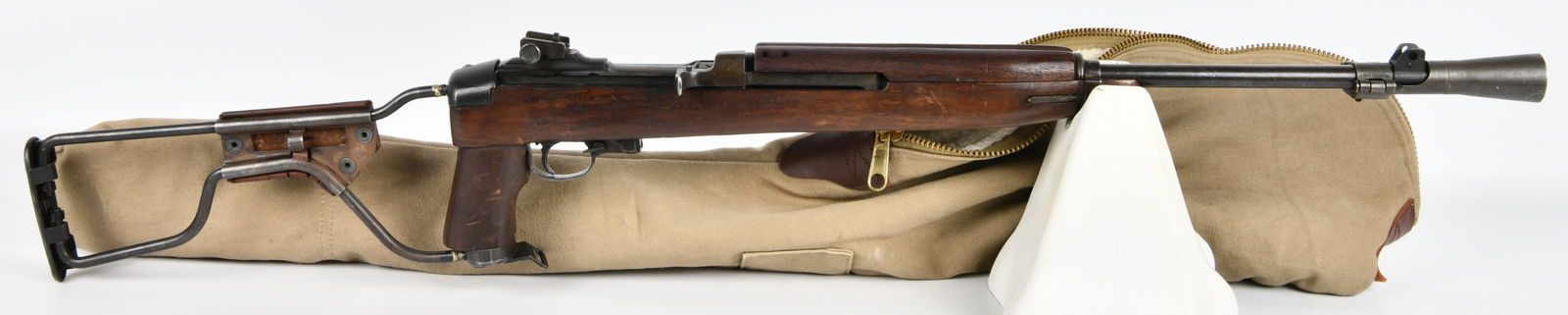 U.S. WWII Rock-Ola M1A1 Paratrooper Carbine with Jump Case: A U.S. WWII Rock-Ola M1A1 Paratrooper Carbine, identified by visible markings 'ROCK-OLA', 'U.S. CAL. 30 M1', and serial number '4613901'. This mid-20th century military firearm features a dark wooden