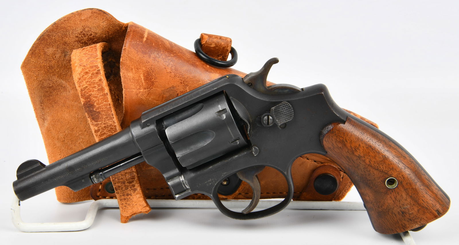 Smith & Wesson US Property Victory Model Revolver Rig: A Smith & Wesson US Property Victory Model revolver rig. The revolver features a dark blued steel finish, a six-shot cylinder, conventional fixed sights, and plain wooden grip panels. Markings on the