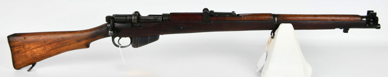 Lee Enfield No. 1 Mk. III* SMLE Bolt Action Rifle, Likely Australian Lithgow: A Lee Enfield No. 1 Mk. III* SMLE bolt-action military rifle, primarily constructed with a multi-toned wooden stock and forend, steel components with a worn blued finish, and a brass butt plate featur