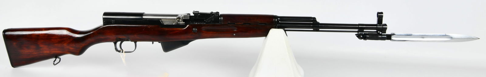 1953 Soviet Russian Tula SKS 7.62x39mm Semi-Automatic Rifle: A 1953 Soviet Russian Tula SKS 7.62x39mm semi-automatic rifle. Constructed from blued steel and polished dark wood, featuring an integral folding bayonet with a bright metal blade. Distinctive marking