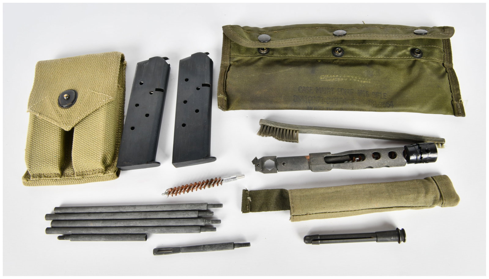 A Collection of US Military M16 Rifle Cleaning Kit Components, WWII-Era Pouch, and Firearm: A collection of mid-20th century US military firearm accessories, prominently featuring components for an M16 rifle cleaning kit. The lot includes a larger olive drab canvas pouch marked "CASE INST. F