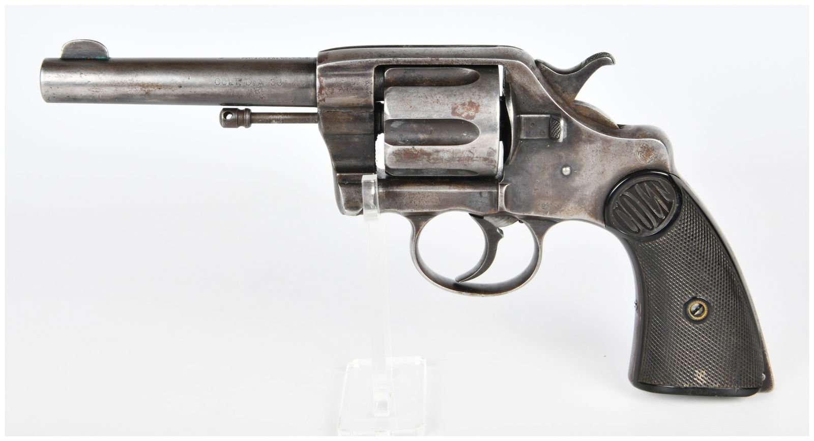 Colt Model 1889 Navy .38 Caliber Double Action Revolver: A Colt Model 1889 Navy .38 Caliber Double Action Revolver, constructed of steel with checkered hard rubber grips featuring an oval "COLT" logo. The top of the barrel is marked "COLT'S PT. F.A. MFG. CO