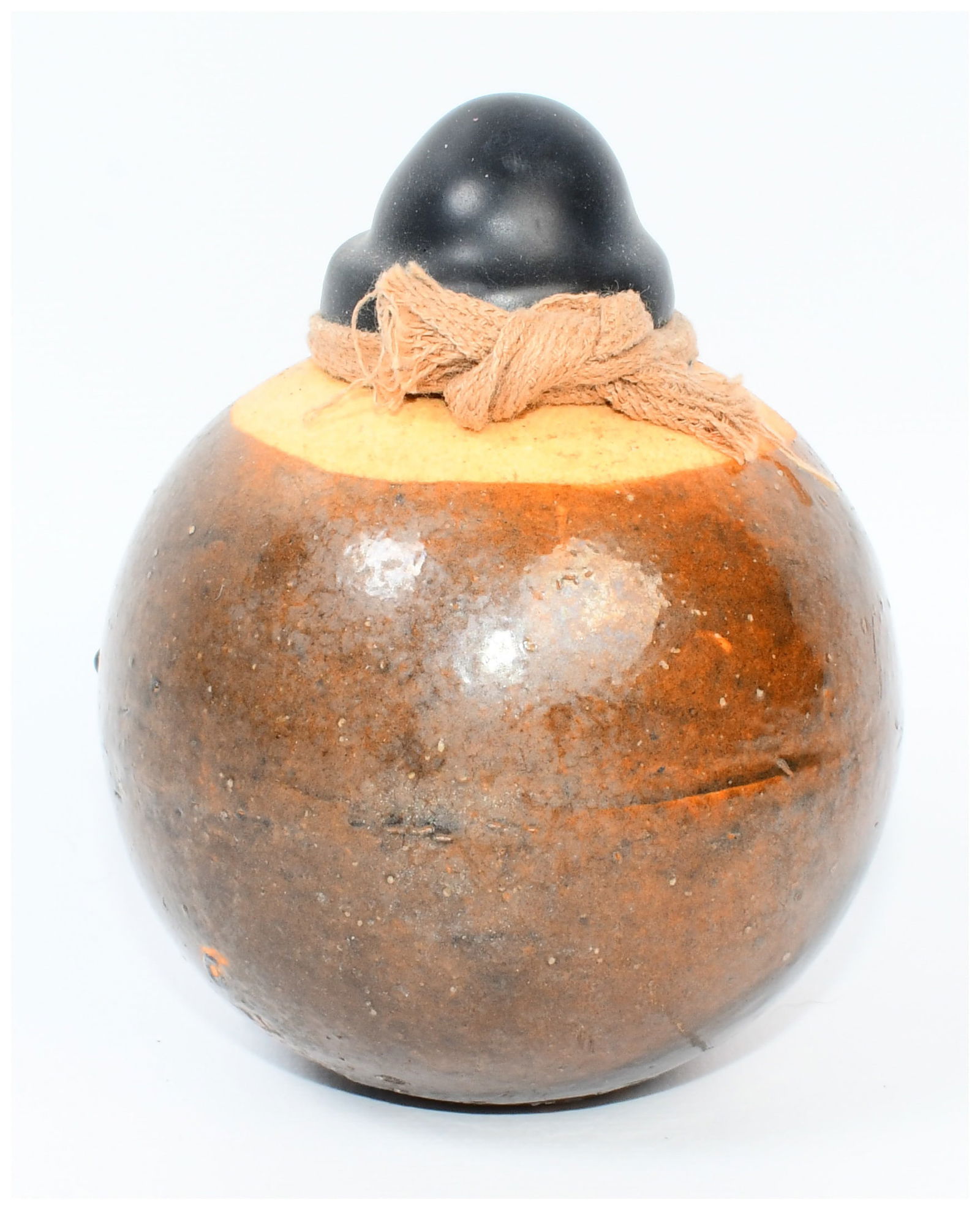 Original Japanese WWII Type 4 Ceramic Hand Grenade in Glazed Brown: An Original Japanese WWII Type 4 Ceramic Hand Grenade in Glazed Brown. This spherical ceramic vessel features a rich, speckled brown and orange glaze, with an unglazed or lighter tan band encircling t