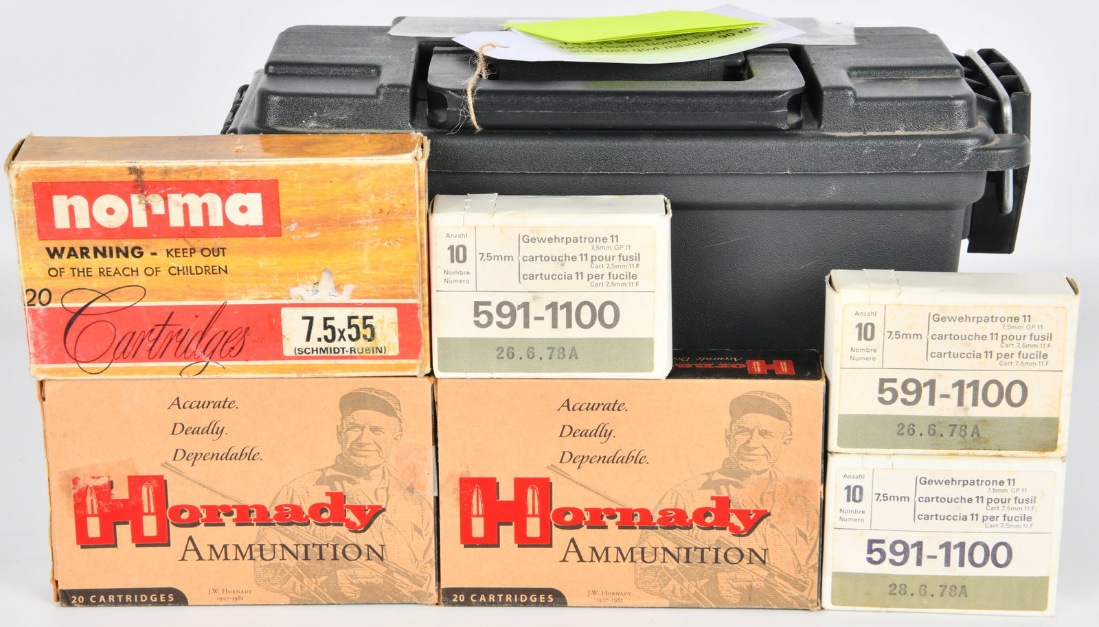 A Plastic Ammunition Can and a Group of 7.5x55 and 7.5mm Rifle Cartridges: This lot comprises a dark green plastic ammunition can alongside multiple boxes of rifle cartridges. The cartridges include one vintage-style Norma brand box for 20 7.5x55 (Schmidt-Rubin) caliber cart