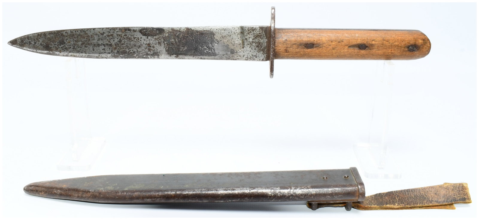 WWI Austro-Hungarian M1917 Trench/Fighting Knife with Scabbard: A WWI Austro-Hungarian M1917 Trench/Fighting Knife, accompanied by its scabbard. This fixed-blade knife features a plain, possibly spear-point steel blade. A simple metal crossguard separates the blad