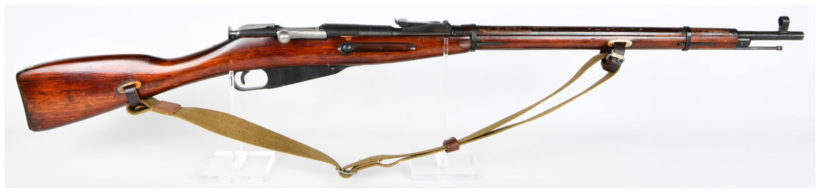 Soviet Izhevsk Model 1891/30 Mosin-Nagant Bolt Action Rifle, 7.62x54R, Dated 1943: A Soviet Izhevsk Model 1891/30 Mosin-Nagant bolt-action rifle, dated 1943. This military-style rifle features a dark-stained wooden stock and blued metal components. It is chambered in 7.62 x 54R. Vis