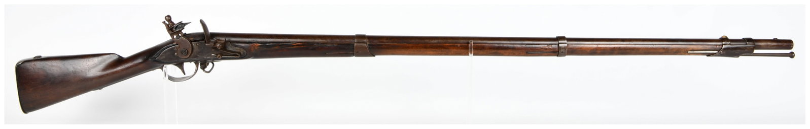 An Antique U.S. Springfield Flintlock Musket, Dated 1807: An antique U.S. Springfield flintlock musket, dated 1807. This long gun is constructed from a dark wooden stock with iron/steel barrel, lock mechanism, and fittings. The lock plate is clearly marked w