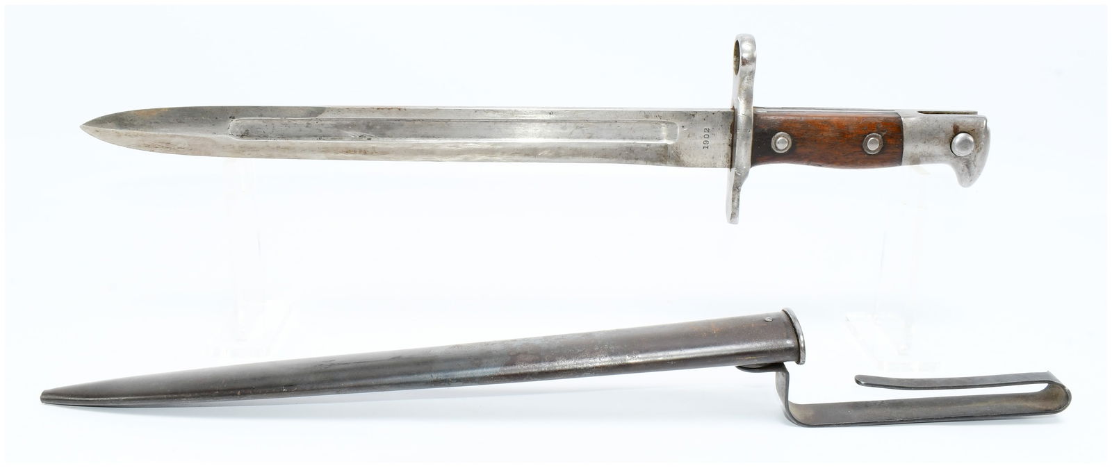 A U.S. Model 1898 Krag Bayonet with Scabbard, Dated 1902: A U.S. Model 1898 Krag Bayonet with Scabbard, dated 1902. This lot comprises a military bayonet with its corresponding metal scabbard. The bayonet features a steel blade with a single fuller, a steel