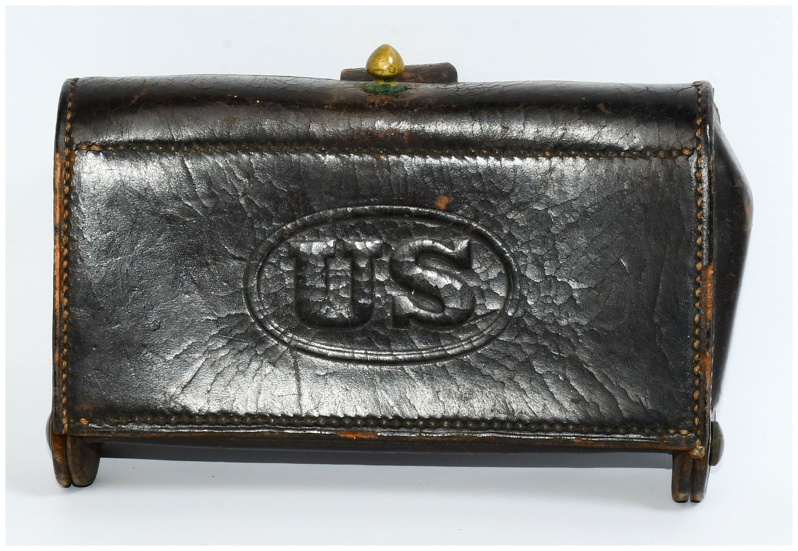 Indian Wars Era US M1874 McKeever .45-70 Cartridge Box: An Indian Wars Era US M1874 McKeever .45-70 Cartridge Box. This military-style leather cartridge box is constructed from thick, dark brown aged leather with visible perimeter stitching. The front flap