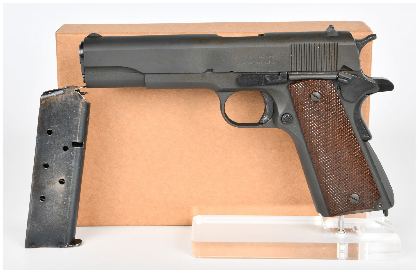Remington Rand M1911A1 U.S. Army Semi-Automatic Pistol: A Remington Rand M1911A1 U.S. Army semi-automatic pistol, constructed of steel with a dark, likely parkerized finish and brown checkered composite grip panels. Markings include "UNITED STATES PROPERTY