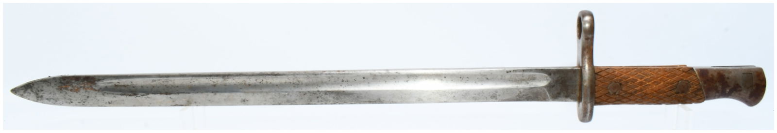 A Spanish Artillery M1913 Bayonet: A Spanish Artillery M1913 Bayonet, constructed with a straight, single-edged steel blade featuring a single fuller. It has a steel crossguard incorporating a muzzle ring and a two-piece wooden grip se