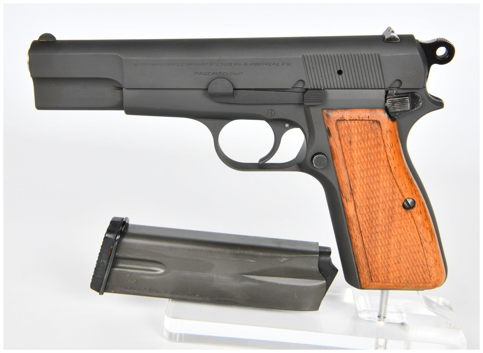 Belgian Browning T-Series Hi-Power Semi-Automatic Pistol, Serial No. T169456: A Belgian Browning T-Series Hi-Power semi-automatic pistol, serial number T169456. This dark finished metal pistol features checkered wooden grip panels. The slide is marked "BROWNING ARMS COMPANY ST.