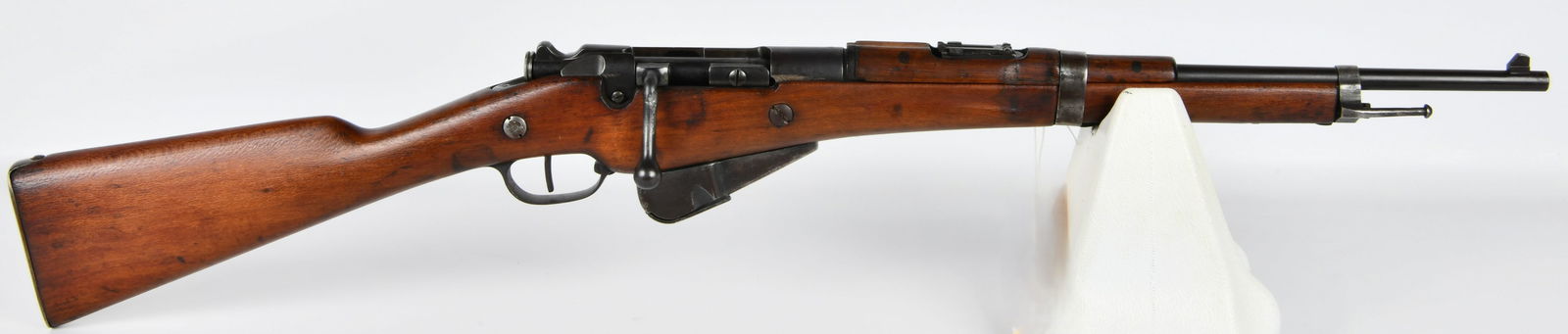 French Est. de Continsouza Berthier Model 1916 Carbine, 8mm Lebel Caliber: A French Est. de Continsouza Berthier Model 1916 Carbine, chambered in 8mm Lebel caliber. This bolt-action rifle is crafted from wood and patinated dark metal, featuring a full-length wooden stock and